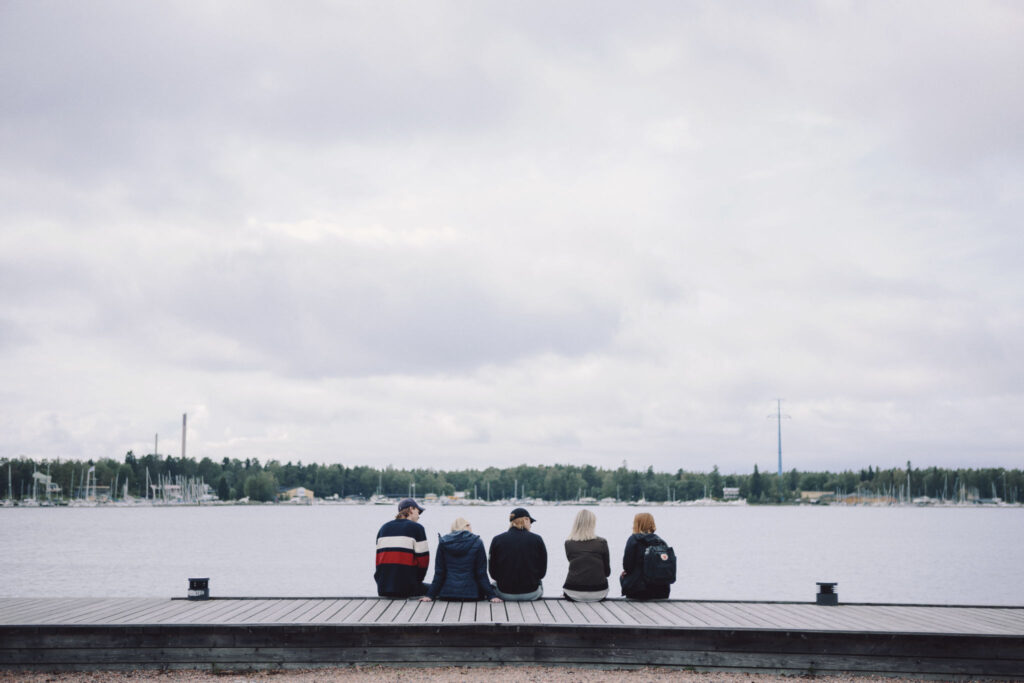 Studerande sitter på kajen.