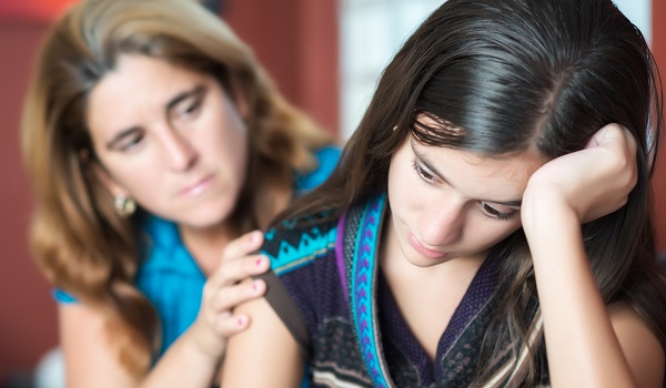 Teenager problems - Mother comforts her troubled teenage daughter