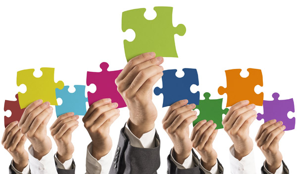 Concept of teamwork and integration with businessman holding colorful puzzle