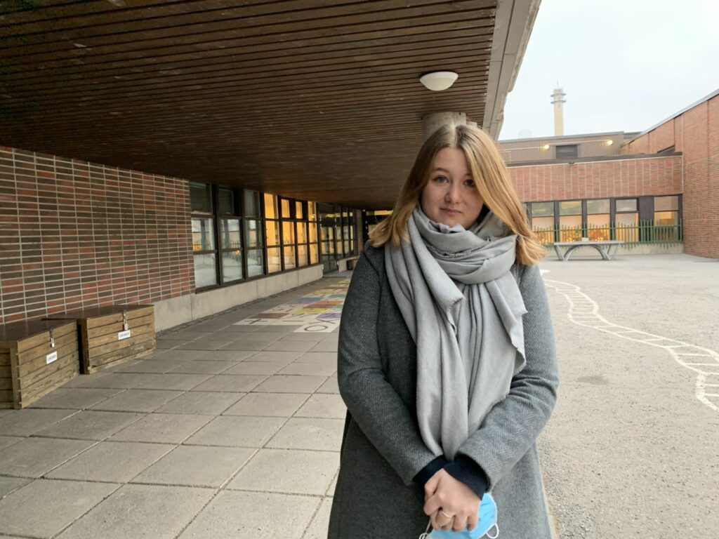 Laura Olesen standing in the schoolyard.