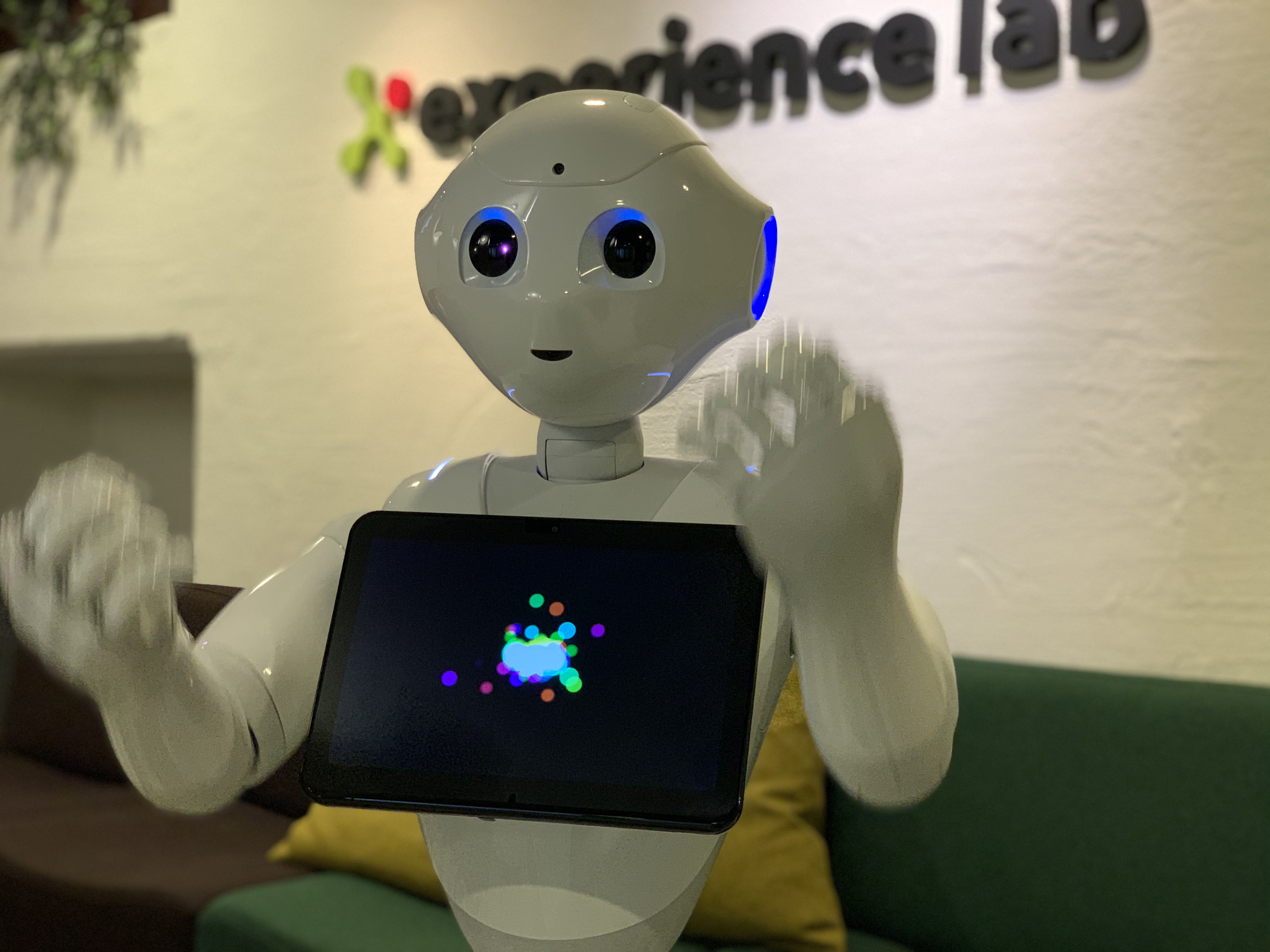 Roboten Pepper gestikulerar med armarna.