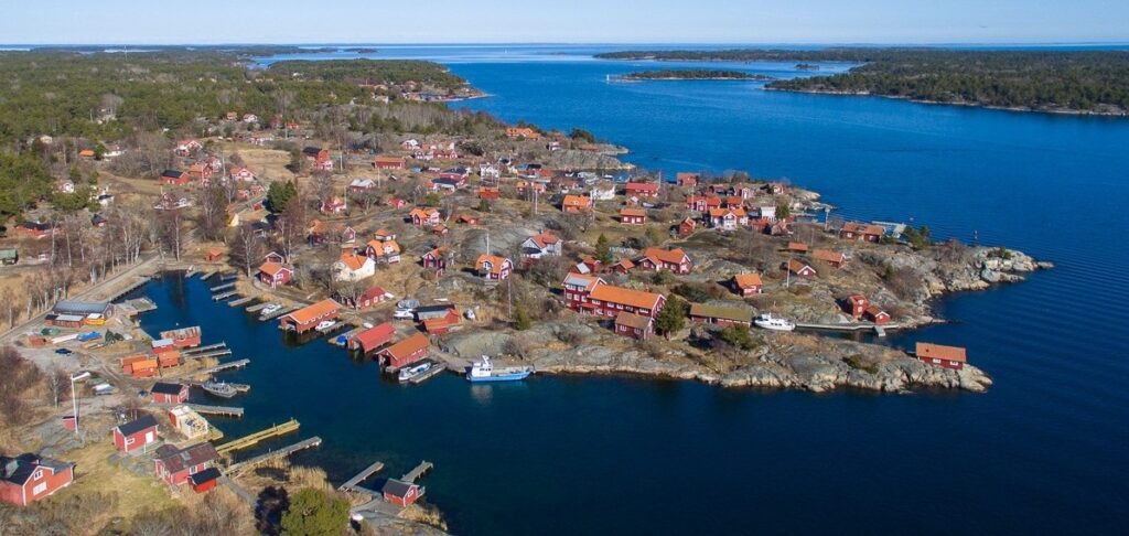 A view over Möja, red houses on a peninsula in the blue sea.
