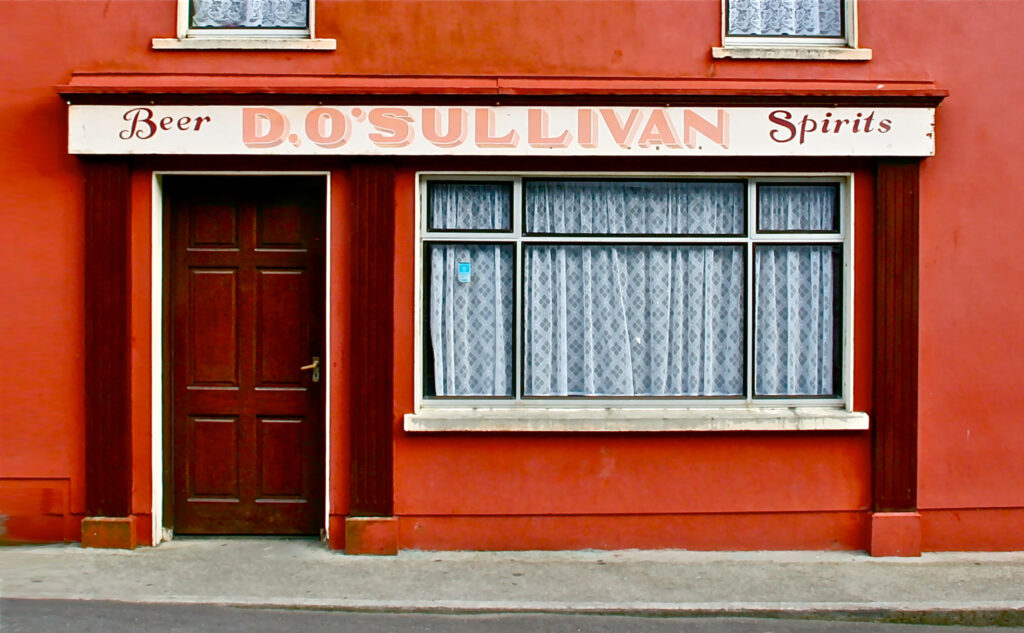 Picture of the pub O’Sullivan's from the outside, the facade is red.