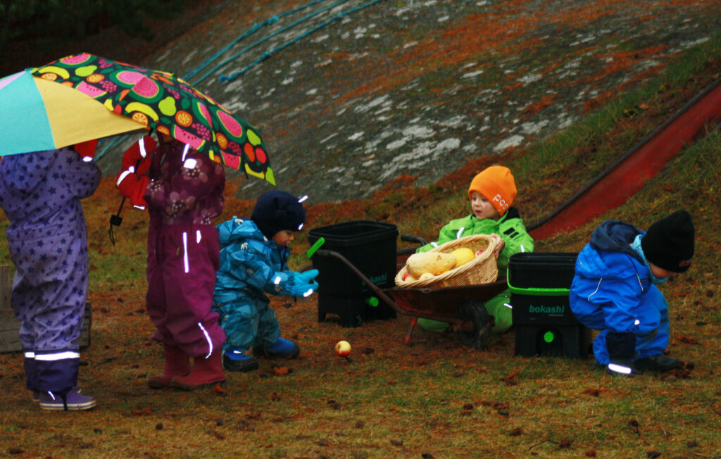 Children outdoors in rainy weather.