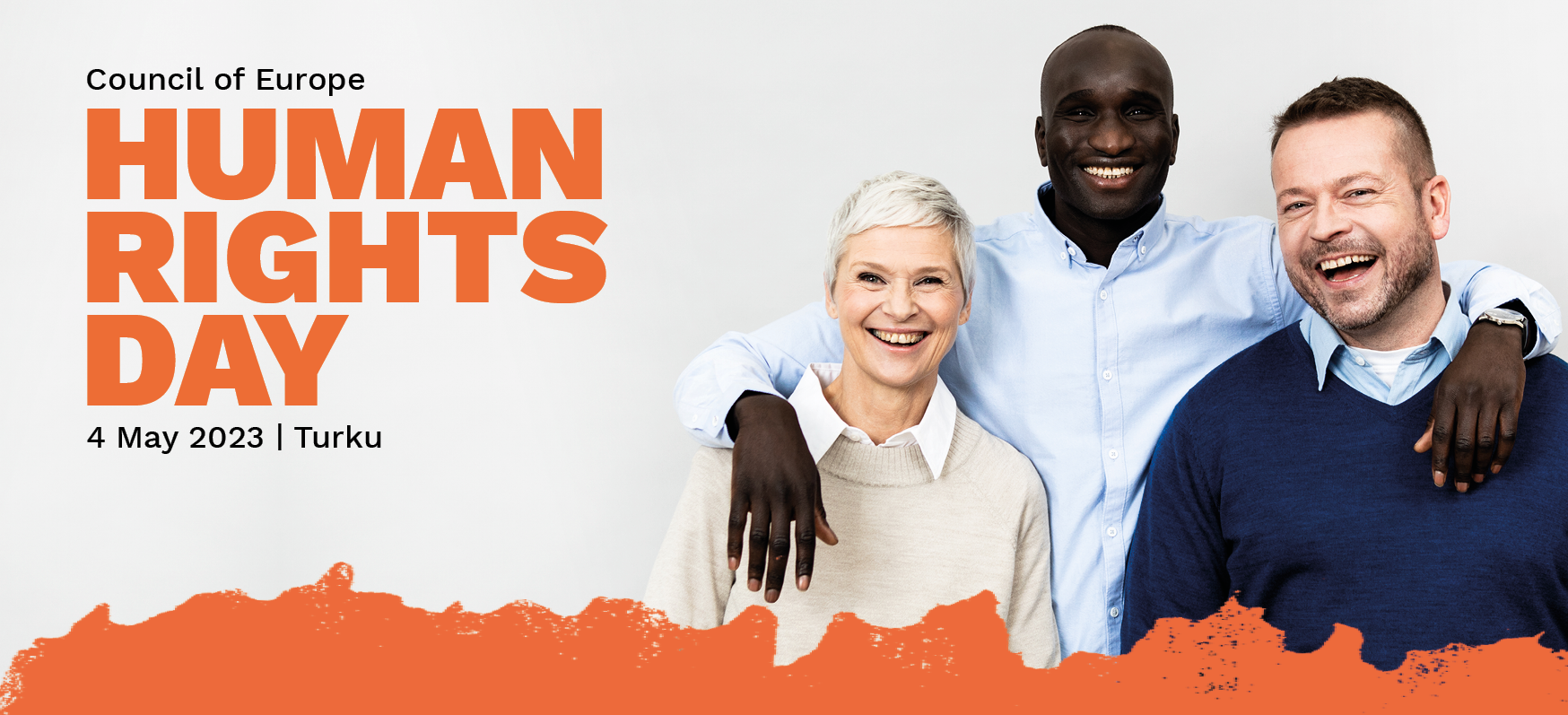 Three smiling persons celebrating the Human Rights Day on 4 May in Turku