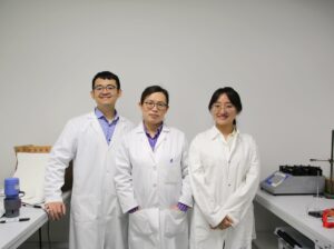 Two women and one man dressed in labcoats.