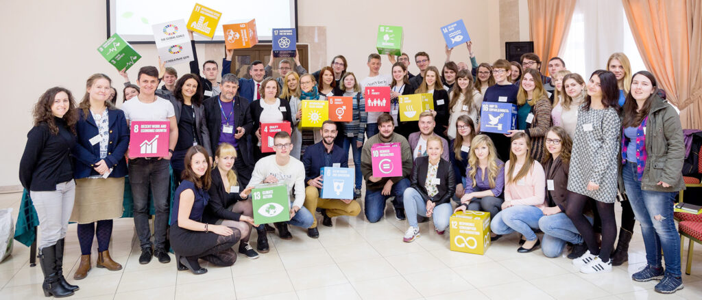 A group of people holding colorful cubes.